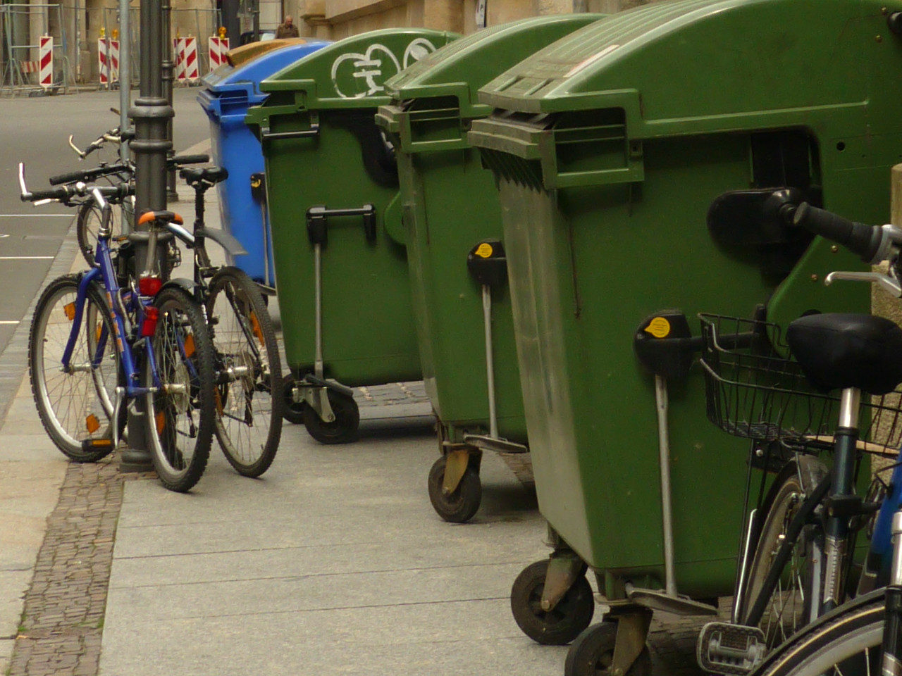 Mit Mülltonnen und Fahrrädern zugestellter Gehweg in der Innenstadt
